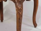 a wooden chair with a brown cushion on top of it