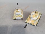 two toy tanks that are sitting on a table