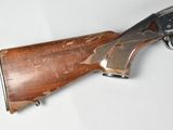 an old gun is laying on a white surface with a white background