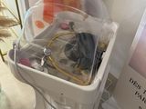 a white trash can with a bunch of items inside of it
