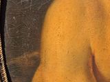 painting of a naked woman in a gold frame on a wall