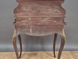an old wooden table with a drawer on top of it
