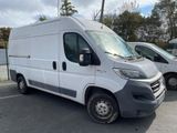 the white van is parked in the parking lot next to other vehicles