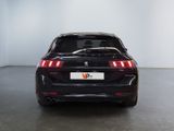 the rear end of a black car in a white room