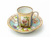 a cup and saucer on a saucer on a white surface