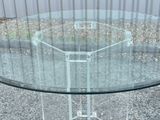 a glass table with a metal base and a glass top