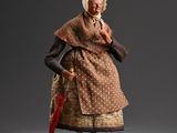 an old woman in a brown dress holding a red umbrella