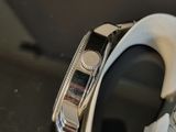 a close up of a watch on a black surface