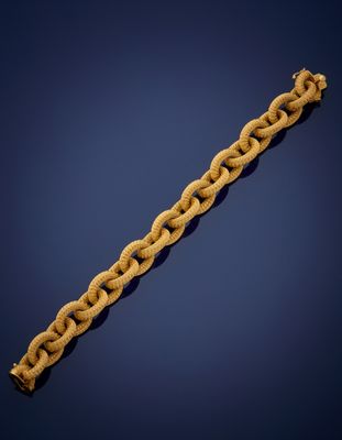 an old rope bracelet with a gold clasp on a blue background