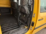 a yellow van with luggage in the back of it