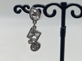 a close up of a pair of earrings on a stand