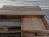 a wooden table with two drawers on top of it