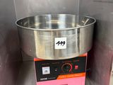 a large metal bowl sitting on top of a machine