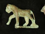 three pieces of ancient bronze figurines of horses on a black background