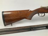 an old rifle with a wooden barrel and a metal handle