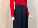 a mannequin with a red top and black skirt