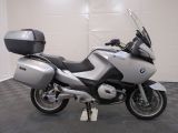 a picture of a silver and black motorcycle parked in a garage