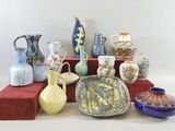 many different types of vases sitting on a shelf