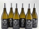 six bottles of wine are lined up in a row on a white surface