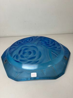a blue bowl on a white counter with a blue lid