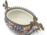 a decorative bowl with a bird decoration on it
