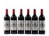 six bottles of wine are lined up on a white surface