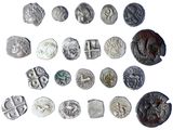 several different types of silver coins are shown on a white surface