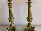 pair of antique brass candlesticks on a marble table