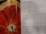 an open book with a picture of a grapefruit on it