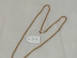 a close up of a gold chain with a tag on it