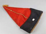 a red and black hat on a white table