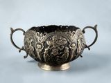 an image of a silver bowl with handles on a blue background