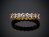 une bague en or jaune sertie de cinq diamants sur fond noir
