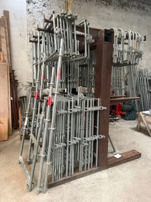 a lot of chairs that are stacked up in a room