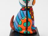 ceramic figurine of a dog sitting on a black base