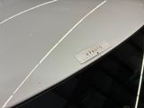a close up of a white car with a name tag on it