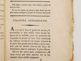 an old book opened to a page with a picture of a cat on it