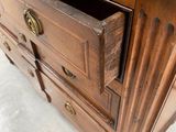 a wooden dresser with a drawer on top of it