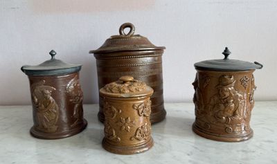 three brown canisters sitting on a counter top