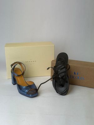 pair of black and blue shoes and a box on a white surface