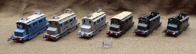 several toy trains are lined up in a row on a table