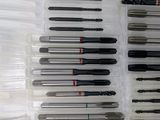 many different types of screws in a plastic container