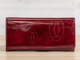 a red leather wallet with two circles on the front and two circles on the back