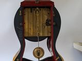 a clock that is sitting on a table next to a book