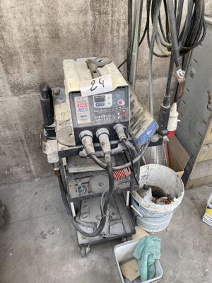 a machine that is sitting on the ground next to a bucket