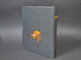 an image of a book with a cat sitting on top of a table