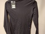 black long sleeved shirt hanging on a hanger on a wall