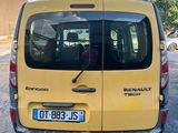 the back of a yellow van parked on the side of a road