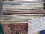 a lot of records in a box on the table