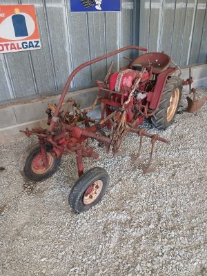 a small tractor that is parked next to a building
